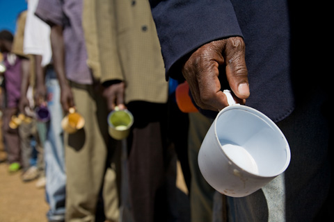 Men wait in line for food at IDP camp in Kenya following post el