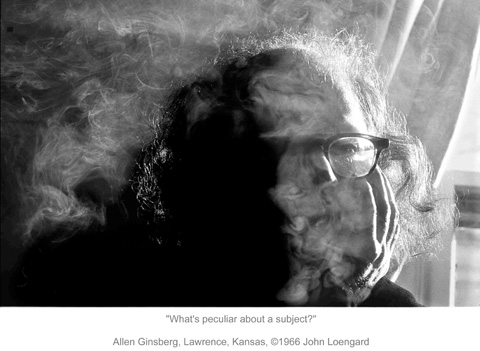 Allen Ginsberg in a cloud of smoke, half of his face in shadow, the other half in light.