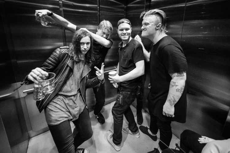 Spencer Chamberlain, Chris Dudley, and Aaron Gillespie of Underoath take the elevator to the stage with friends on April 24, 2016 at Hard Rock Live in Orlando, Florida